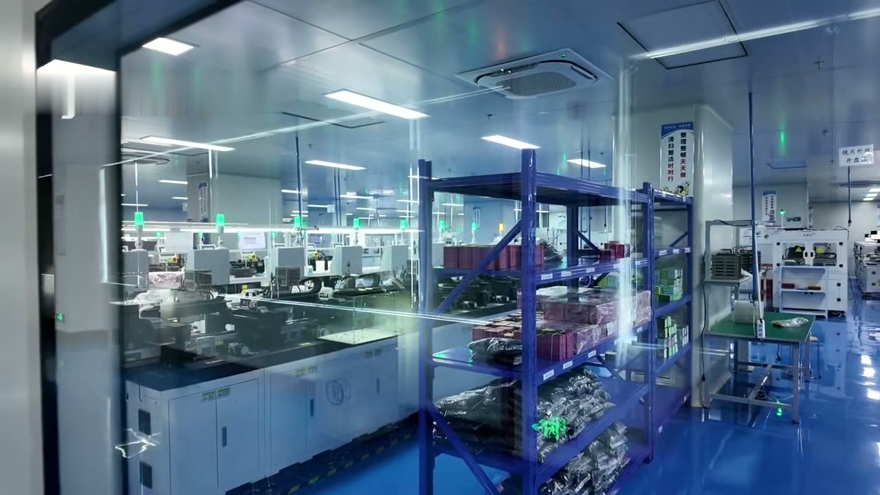 Lensmind cleanroom seen through the glass door, blue floor and alignment stations