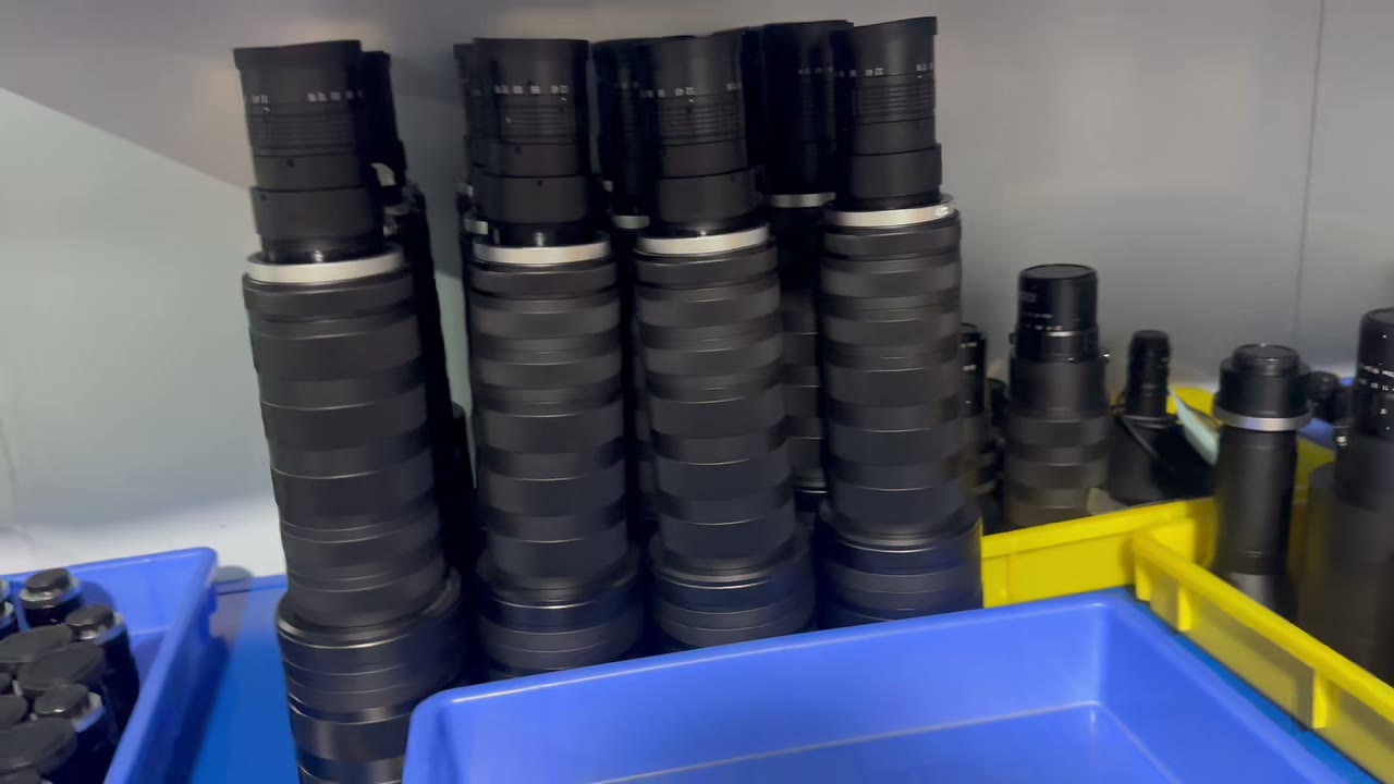 Finished Lensmind machine vision lenses stacked on the production shelf